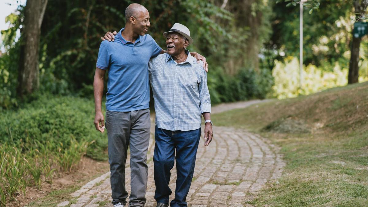 An adult and young person walking together outdoors in a reflective, supportive moment